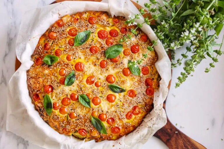 Spanish Tortilla with Tomatoes and Chickpeas garnished with basil leaves.