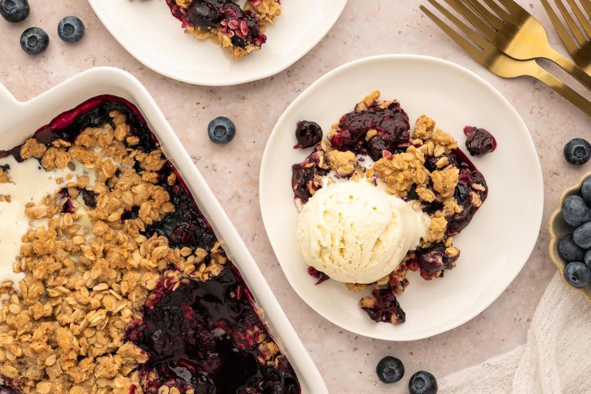 Gluten-Free Blueberry Crisp topped with ice cream.