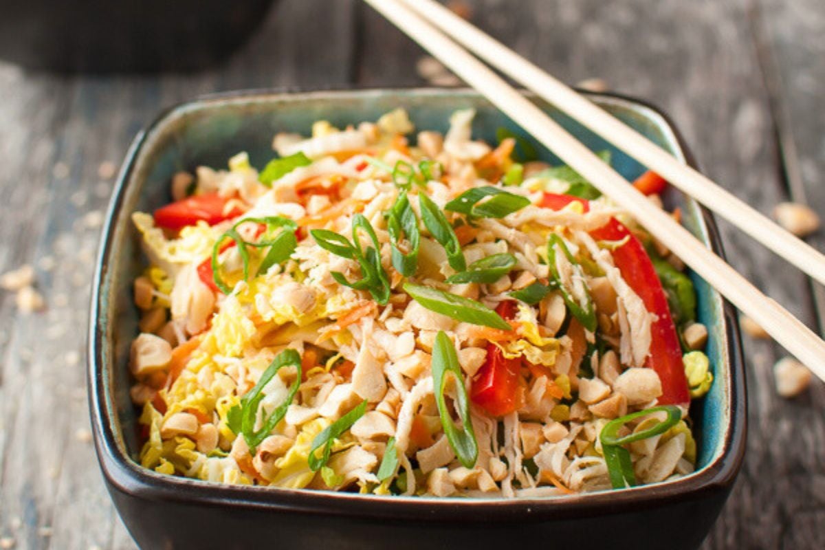 Asian Chicken Salad garnished with spring onions.