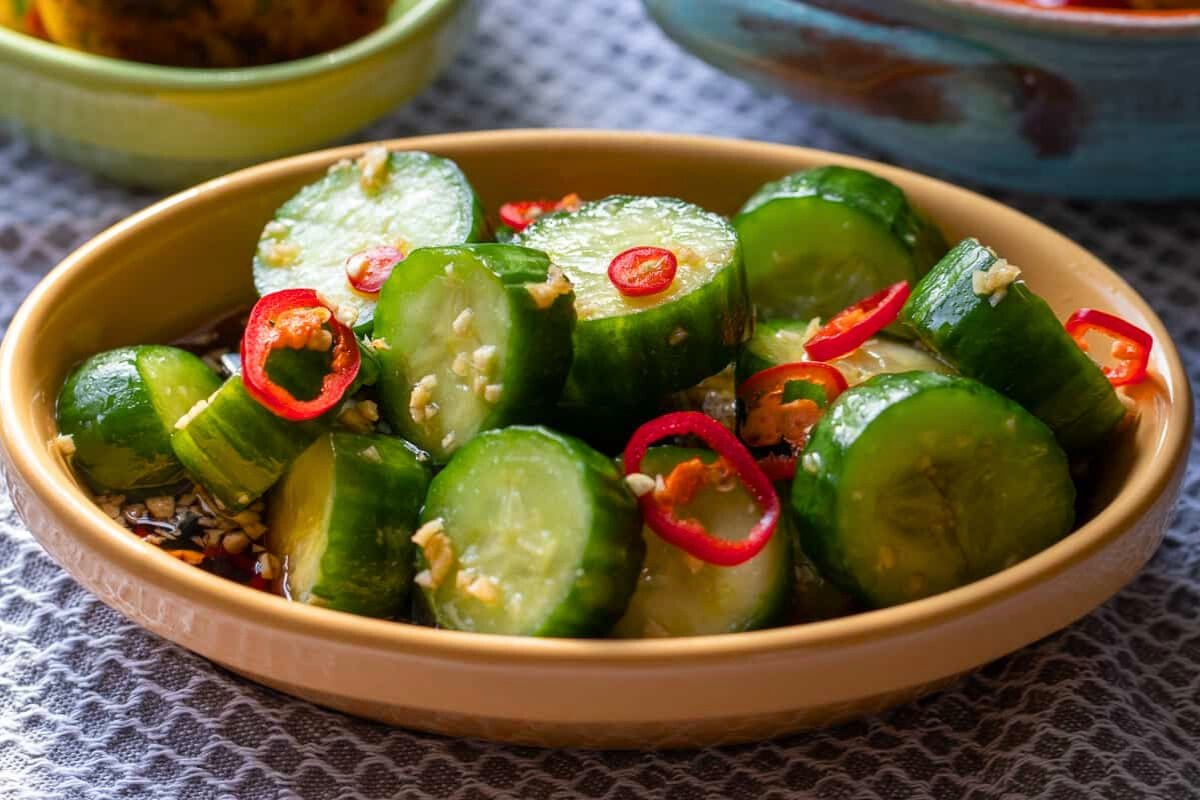Asian Din Tai Fung Cucumber Salad topped with chopped chili.