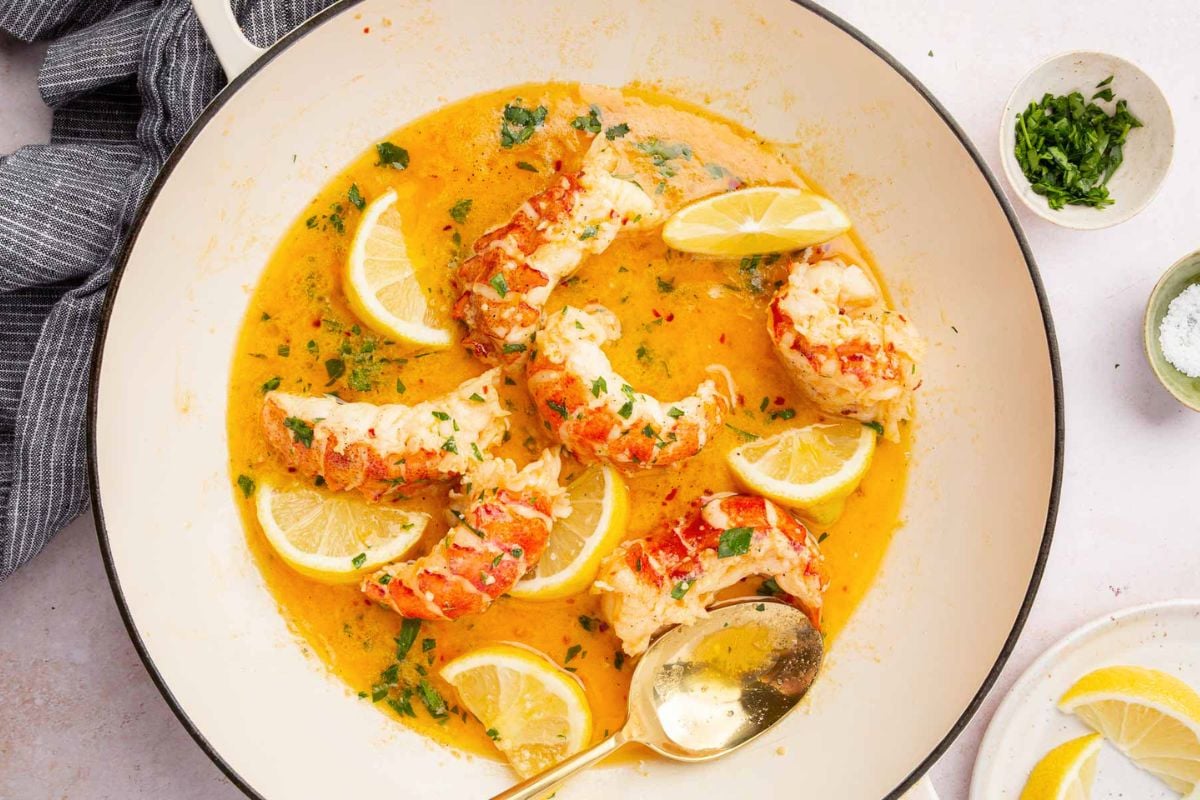 Butter Poached Lobster with sliced lemon.