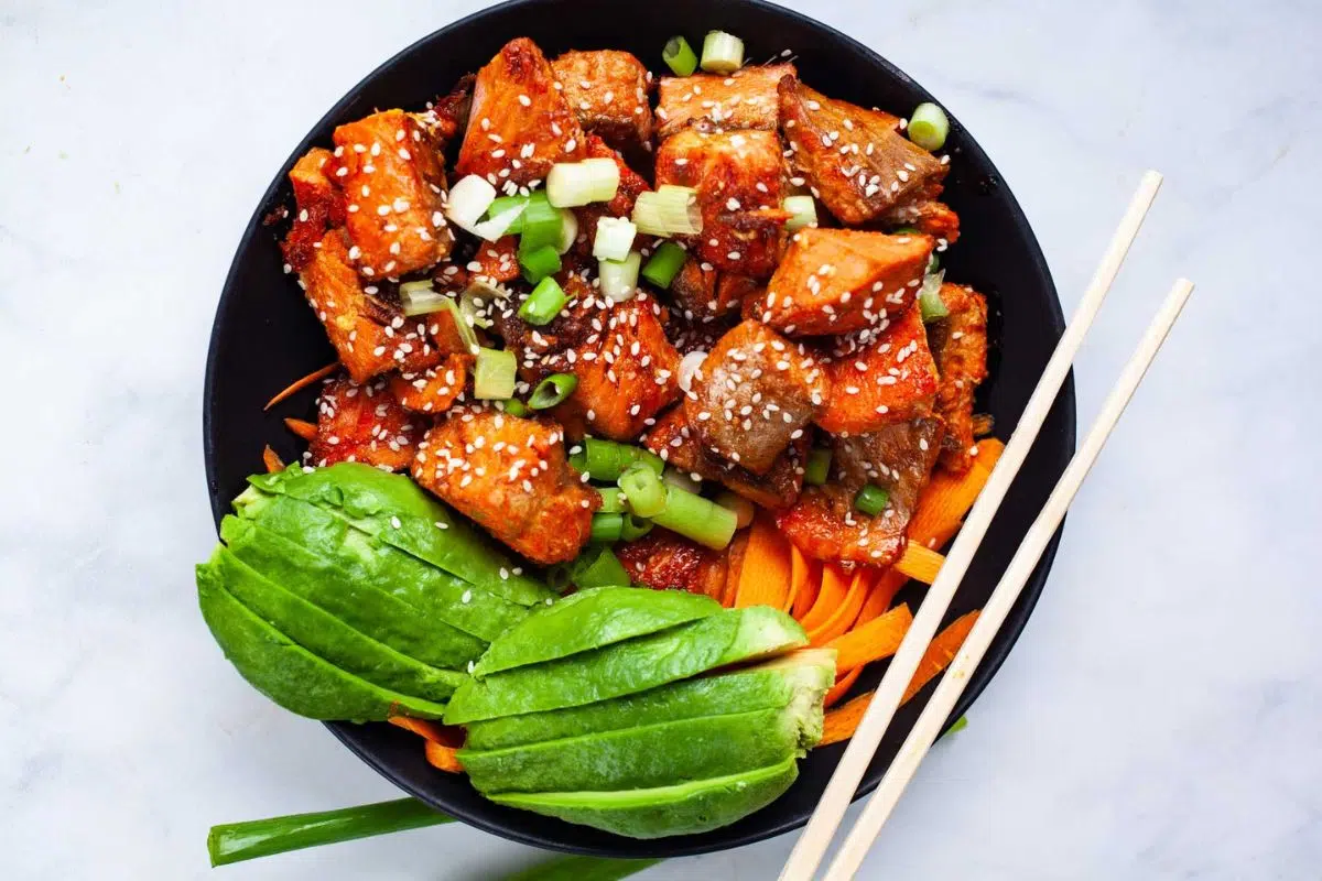 A bowl of Cooked Salmon Poke Bowl With Easy Sauce.