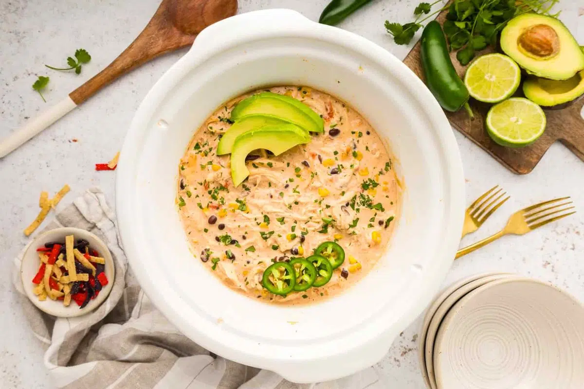 Crockpot White Chicken Chili topped with avocado slices.