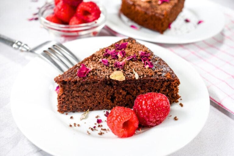 A slice of Flourless Chocolate Cake with Raspberry and Rose.