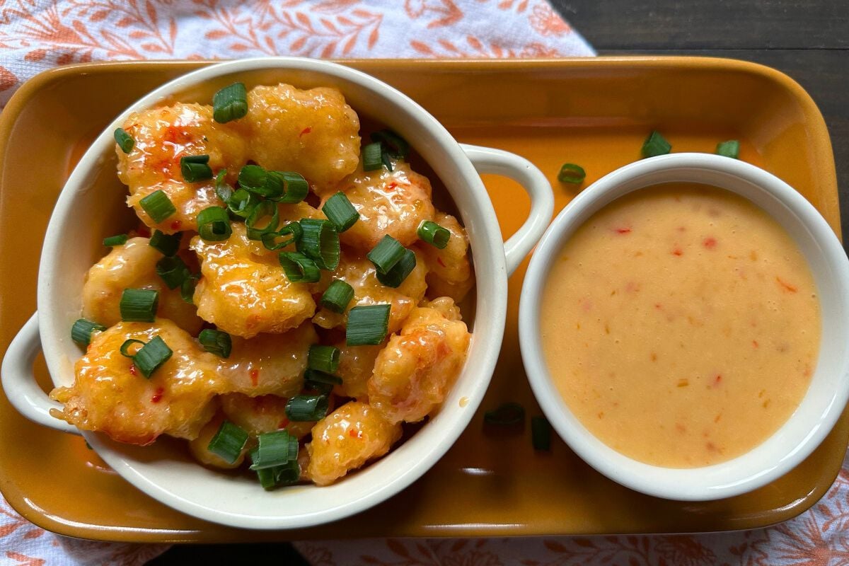 Gluten Free Bang Bang Shrimp garnished with chopped spring onions.