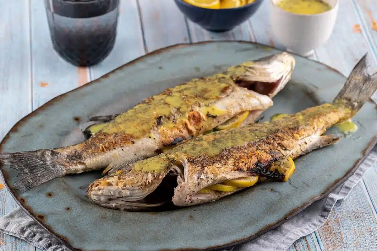 Grilled Sea Bass served on a plate.