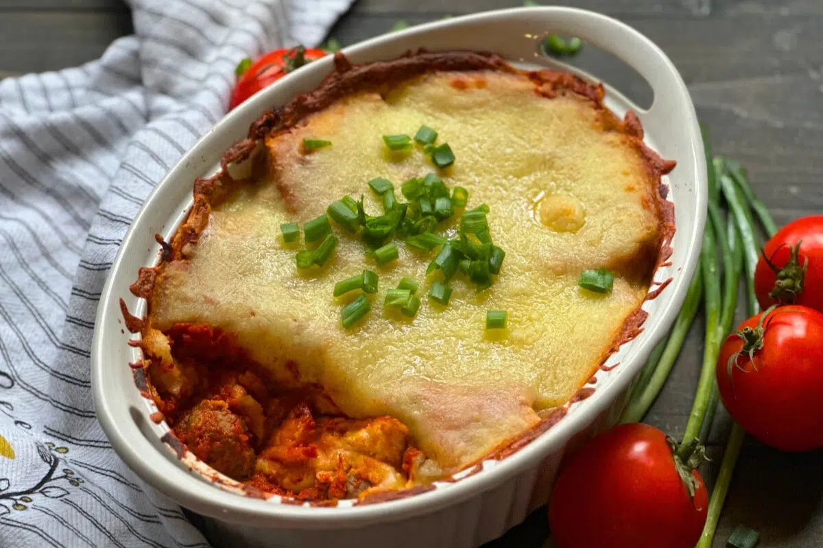 Meatball Sub Casserole topped with chopped spring onions.