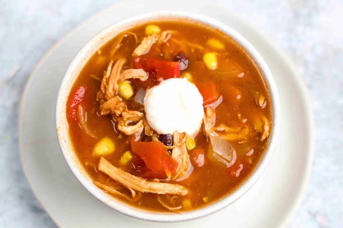 Mexican-inspired Crockpot Chicken Enchilada Soup served in a bowl.
