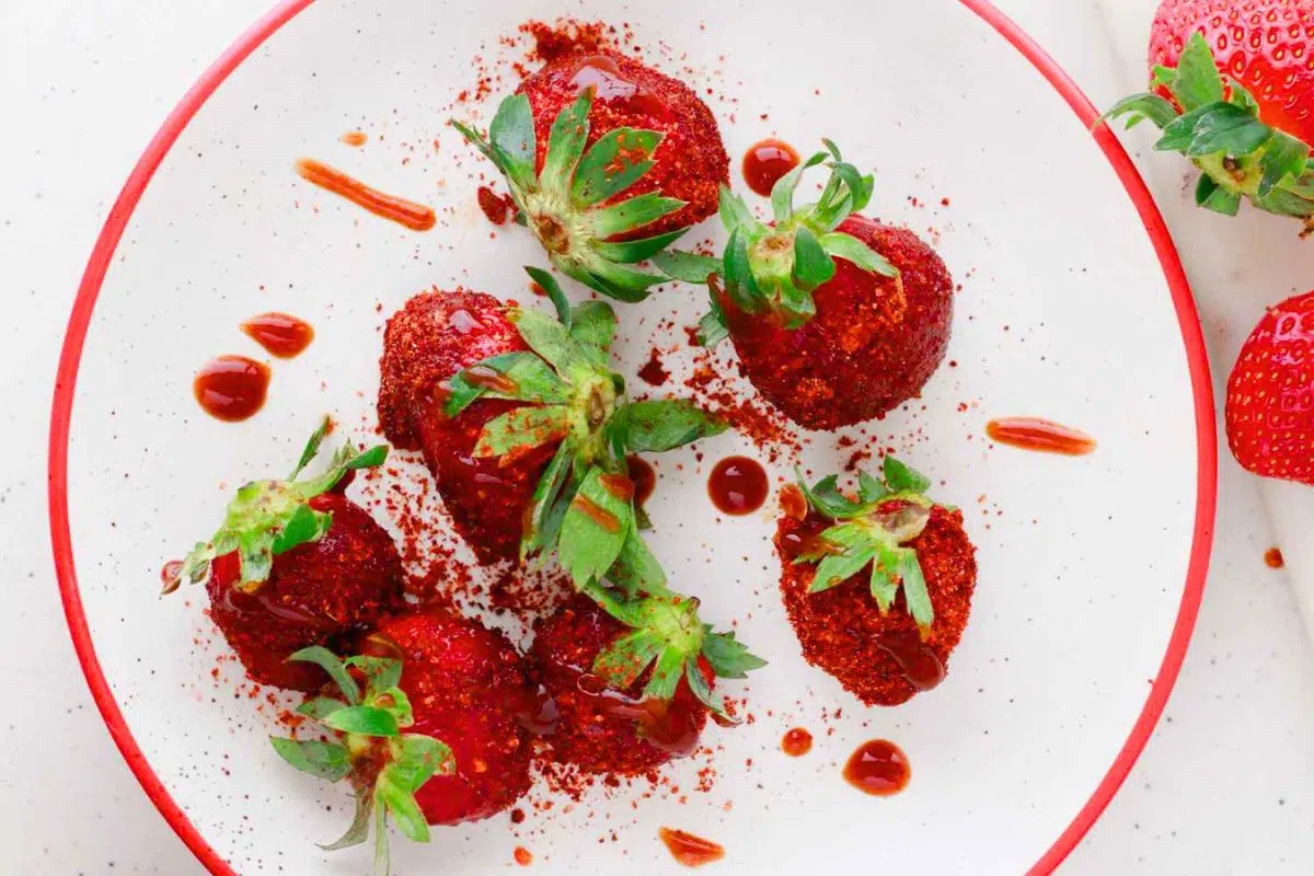 Tajin and Chamoy Strawberries served on a plate.