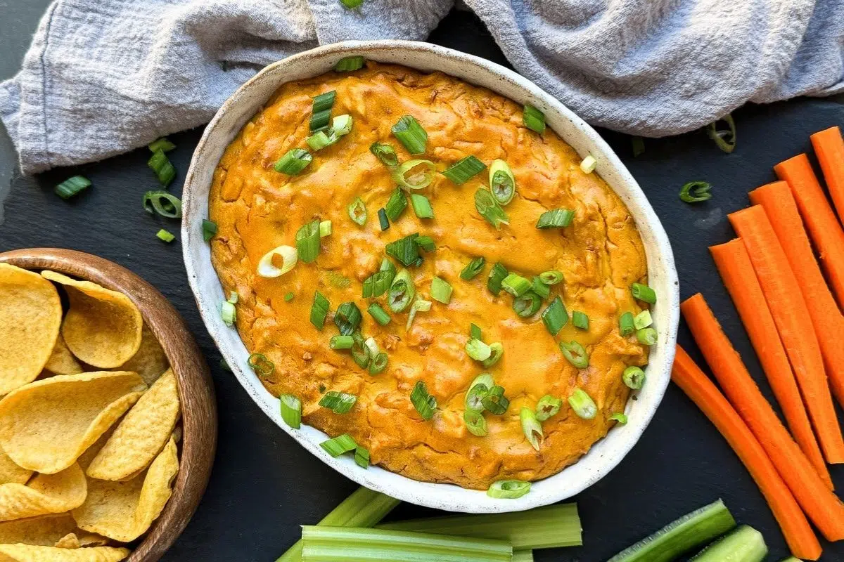 Vegan Buffalo Chicken Dip served with veggies and chips.