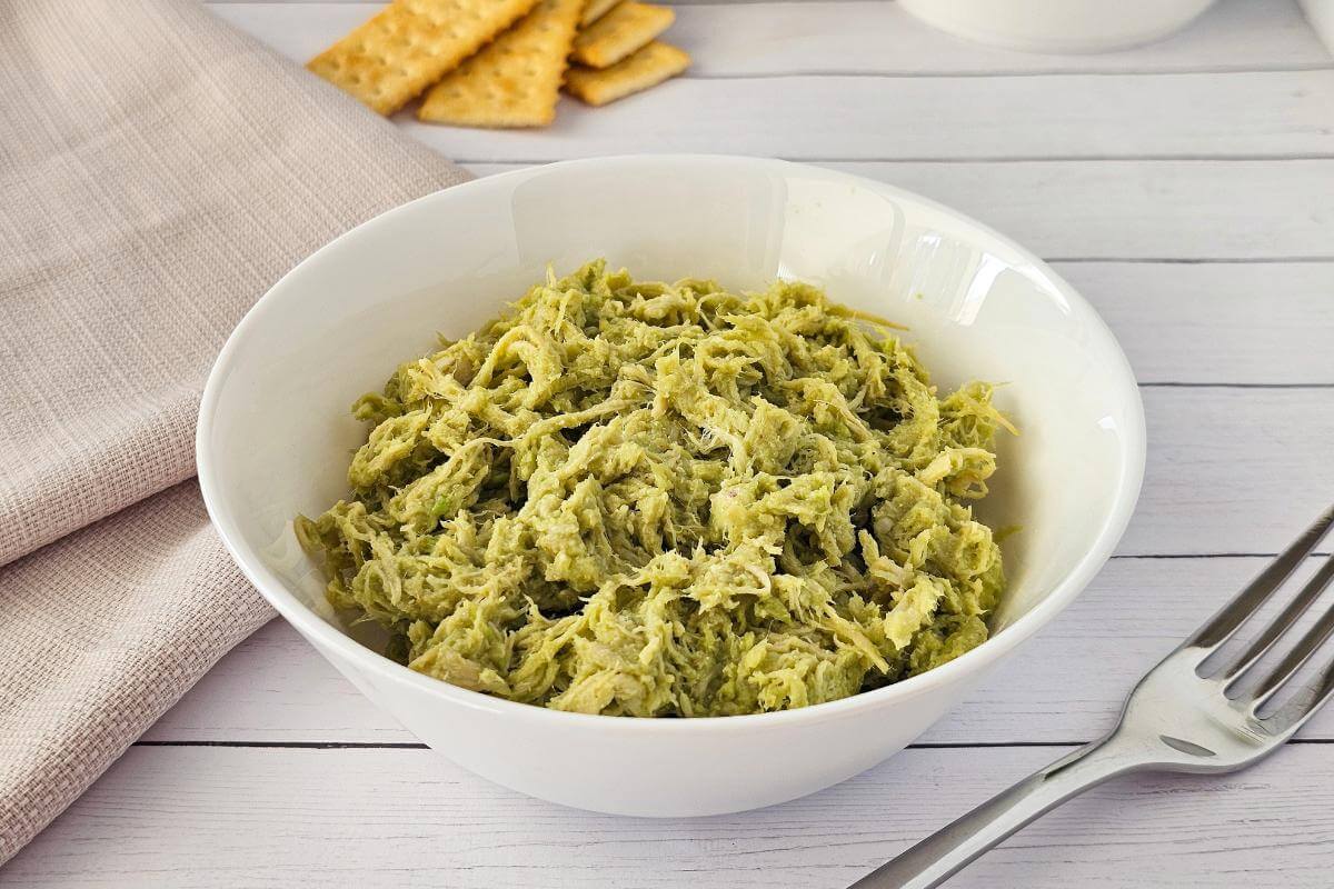 Avocado chicken salad in a white bowl.