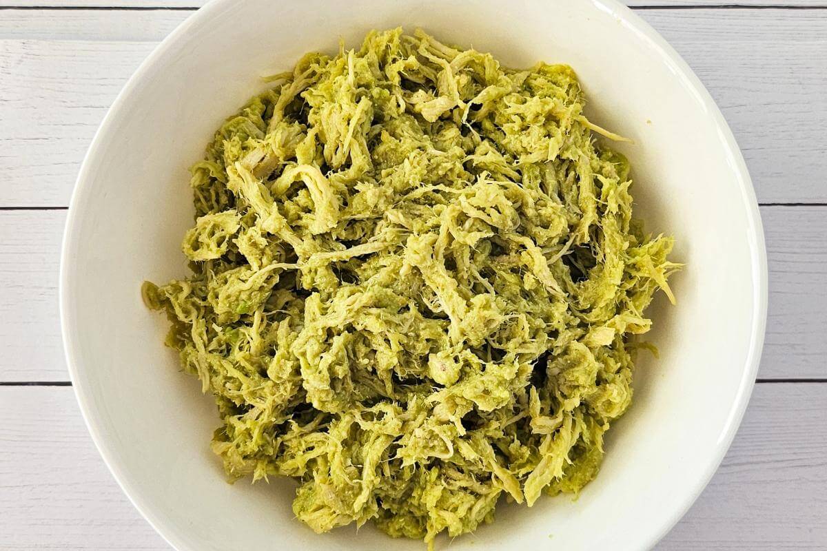 Avocado chicken salad in a white bowl.