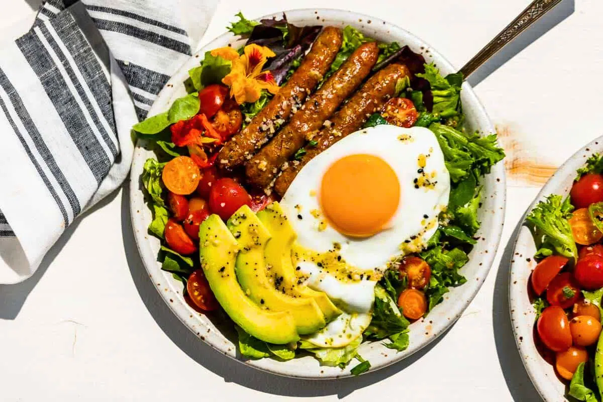 Breakfast Salad topped with fried egg.