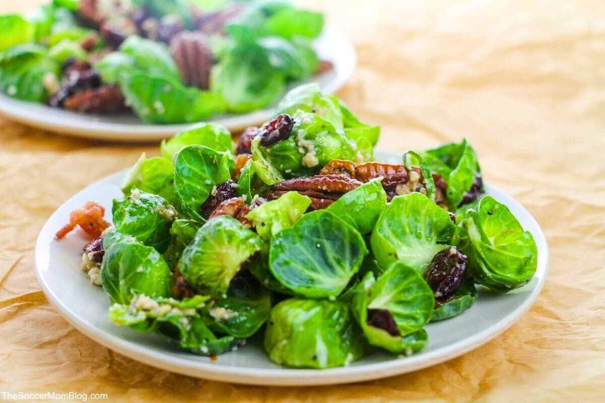 Brussel Sprout Salad with Bacon and Poppyseed Vinaigrette served on a plate.