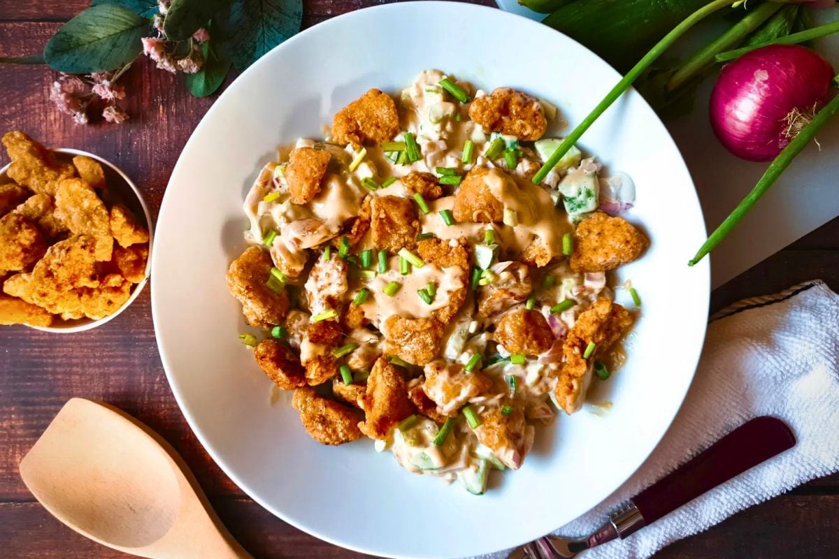 Chicken Salad Recipe with Fried Chicken garnished with chopped spring onions.