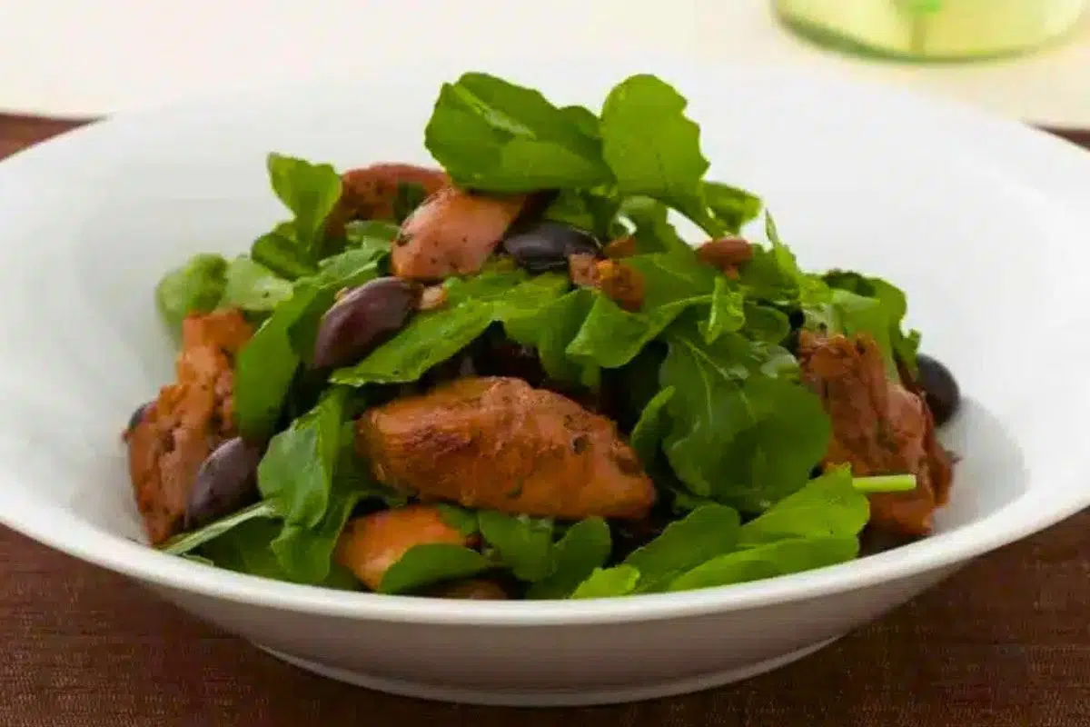 Chicken Salad with Arugula and Kalamata Olives served on a plate.