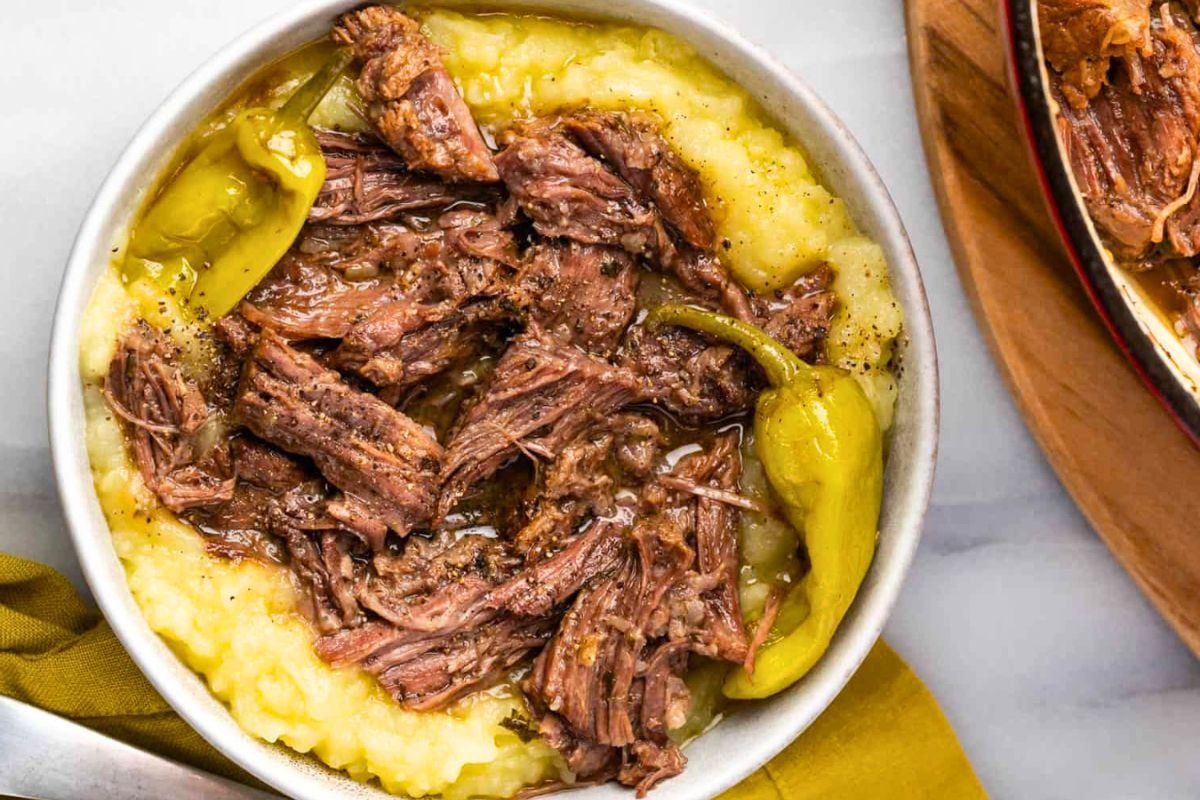 Dutch Oven Mississippi Pot Roast topped on mashed potatoes.