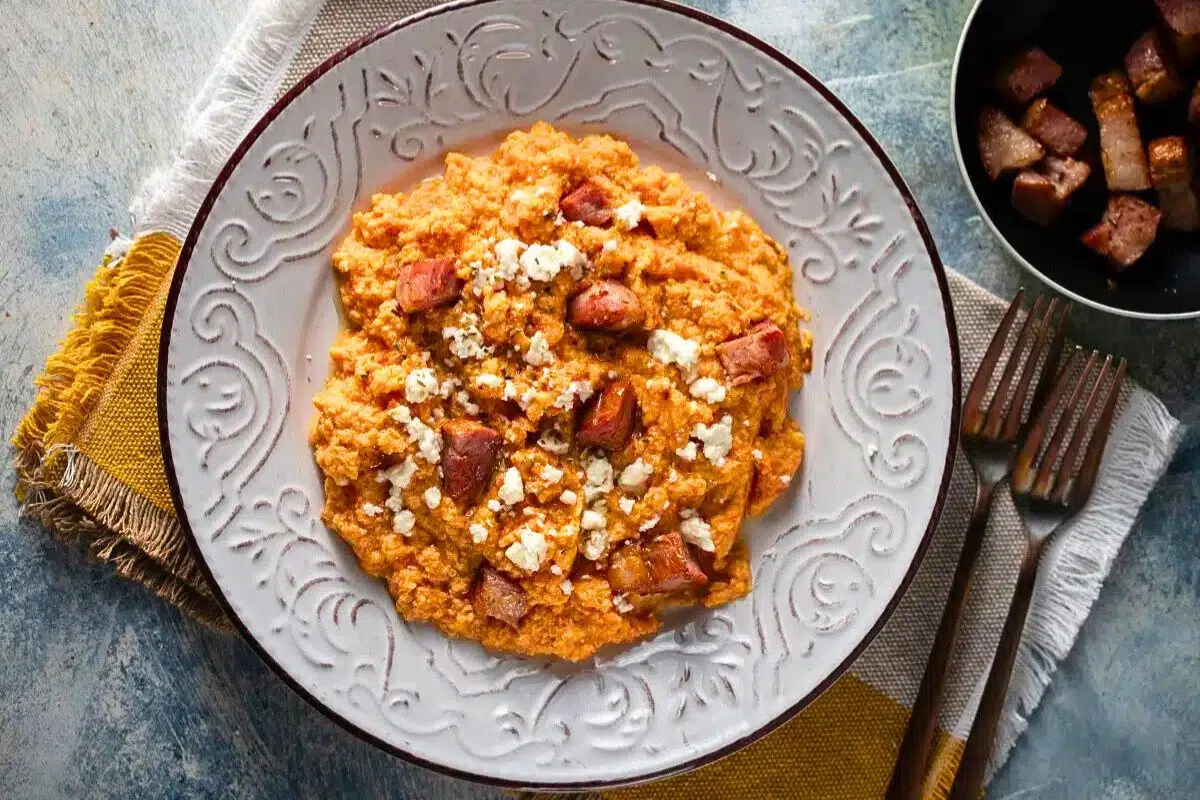 Greek-Style Scrambled Eggs with Feta and Smoked Pork served on a plate.