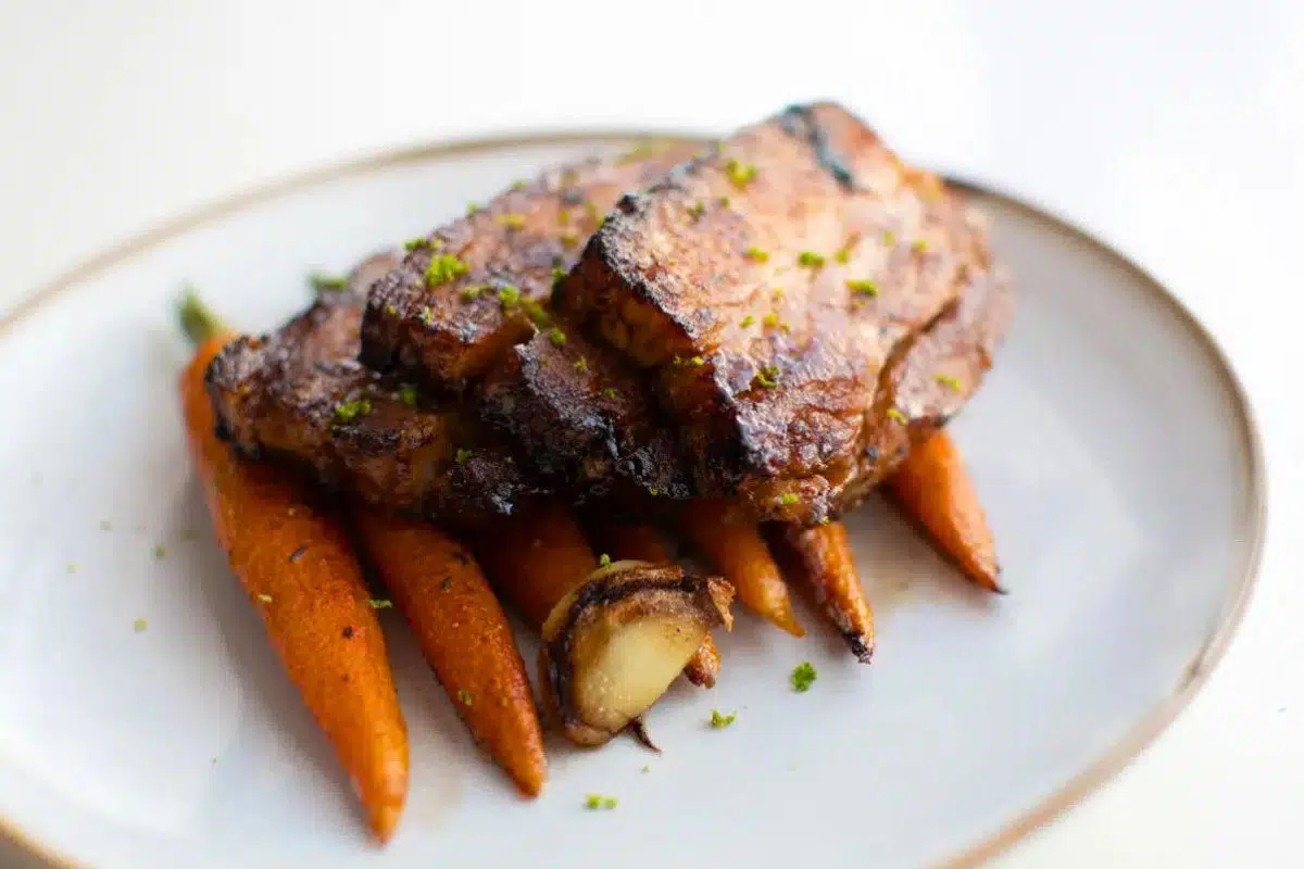 Honey Glazed Fried Pork Belly with Carrots served on a plate.