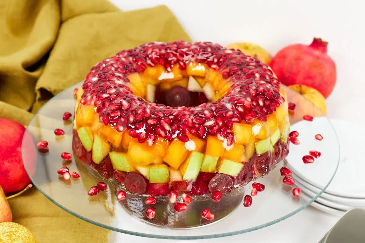 Jello Fruit Cake on a glass stand.