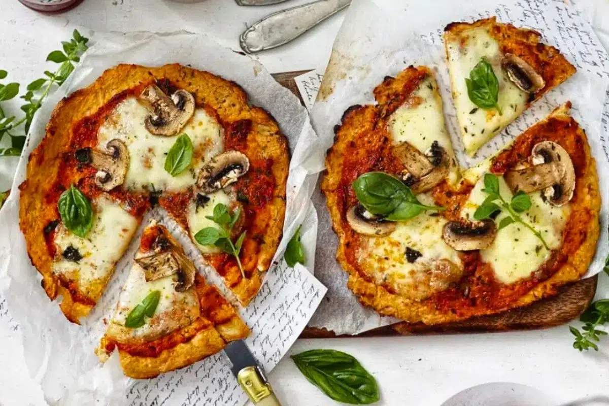 Mozzarella and Mushroom Cauliflower Crust Pizza on a parchment paper.