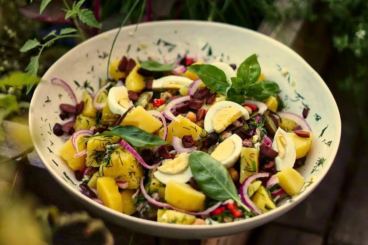 Romanian Potato and Egg Salad served in a bowl.