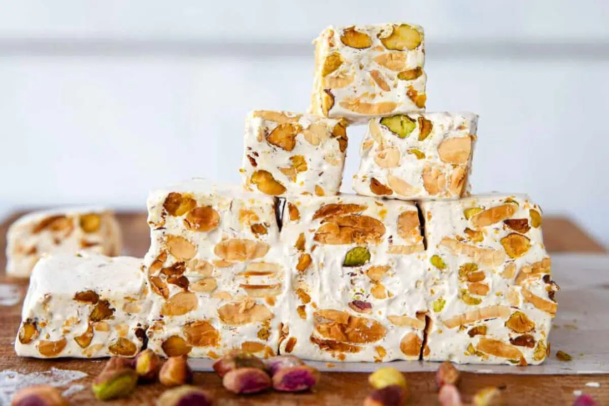Torrone – Italian Nougat on a wooden board.