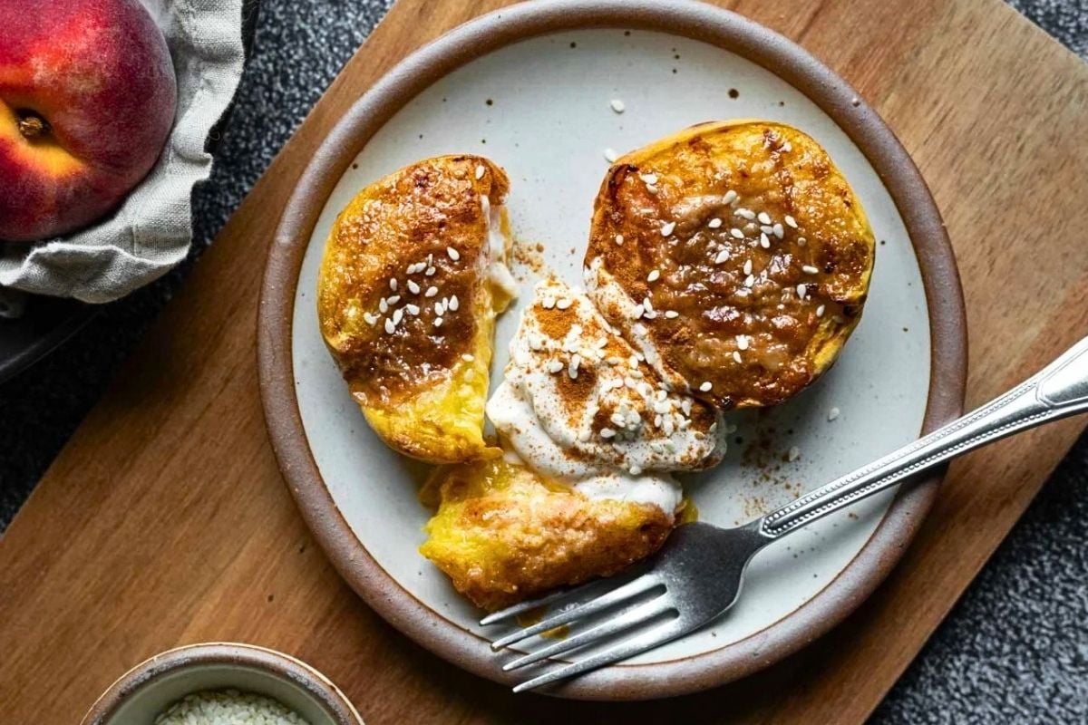 Air Fryer Peaches in plate above the cutting board. 