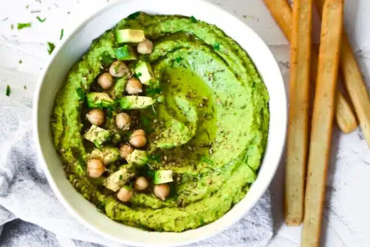 Avocado Hummus with Spinach served in a bowl.