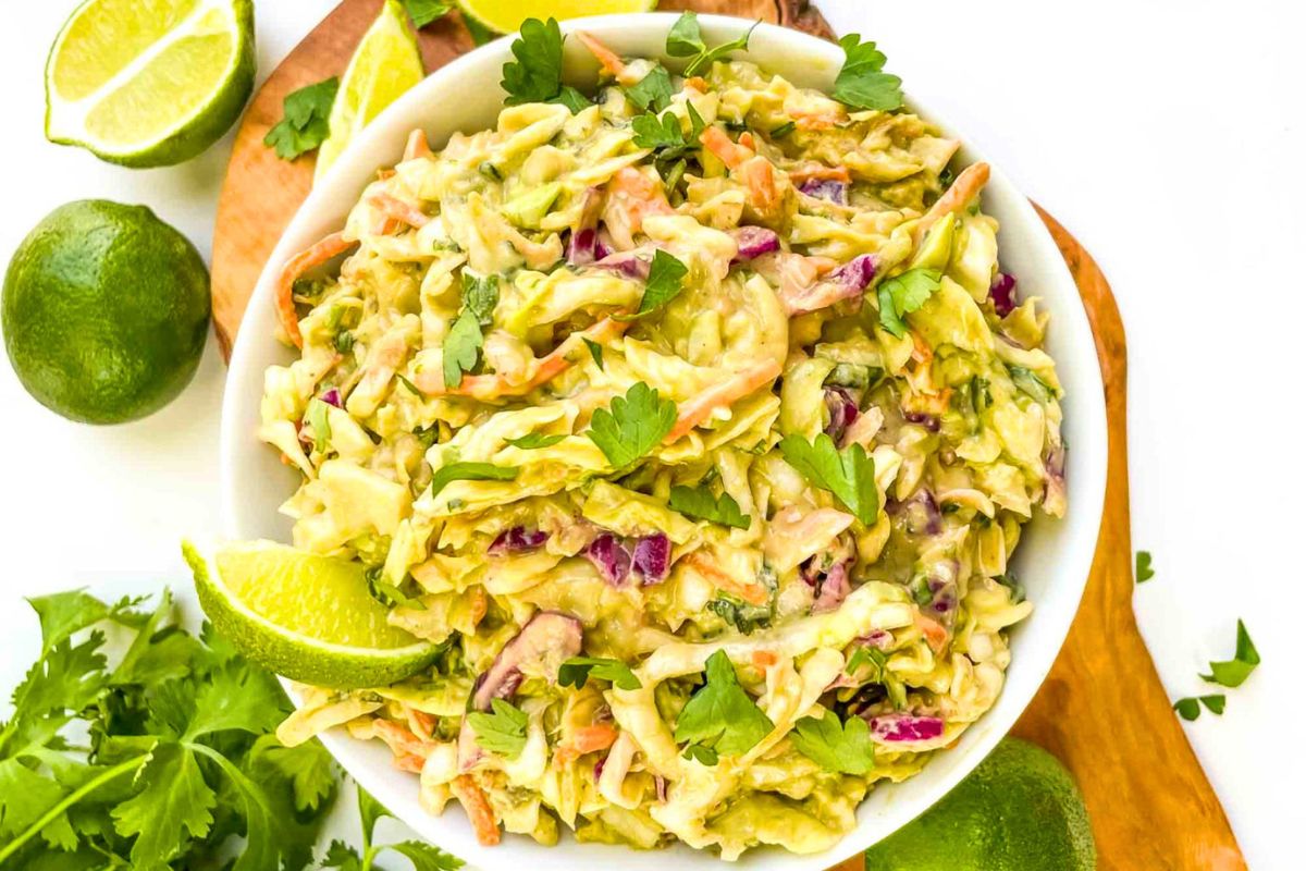 Creamy Avocado Coleslaw served with lime.