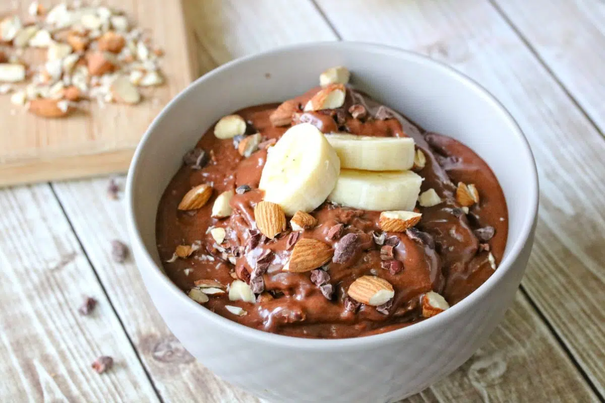 Creamy Chocolate Nice Cream With Peanut Butter Swirl topped with banana slices.