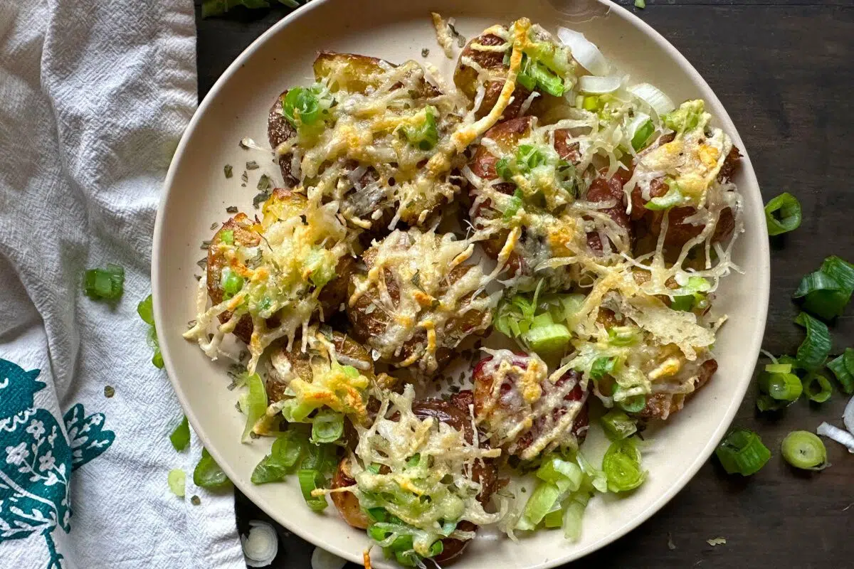 Garlic Parmesan Smashed Potatoes topped with melted chesse.