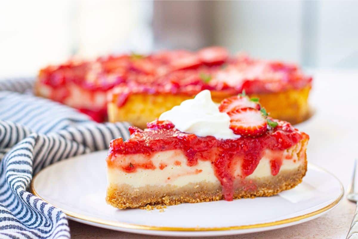 A slice of cheesecake with strawberry topping.