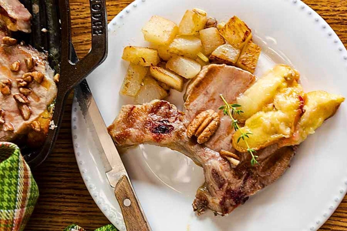 Pork Chops with Peaches and Pecans on a plate.