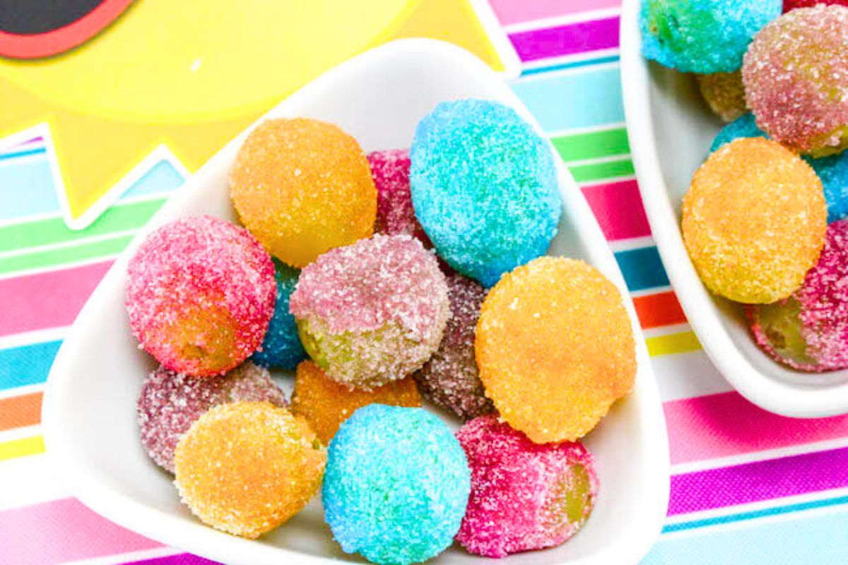 Rainbow Jello Frosted Grapes in a bowl.