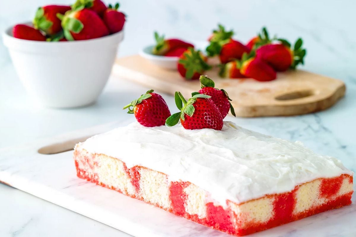 Strawberry Poke Cake topped with strawberries.