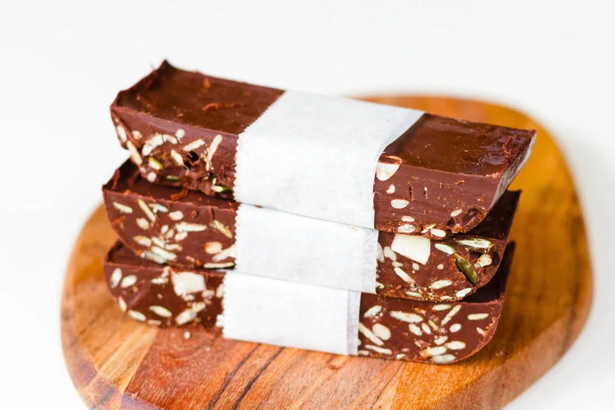 Vegan Dark Chocolate Nut Bars on a wooden board.
