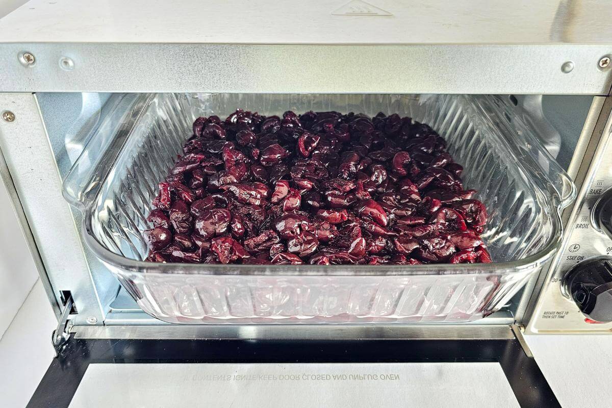 Gluten free cherry crisp being baked in an air fryer.
