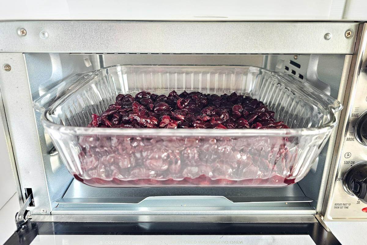 Gluten free cherry crisp being baked in an air fryer.