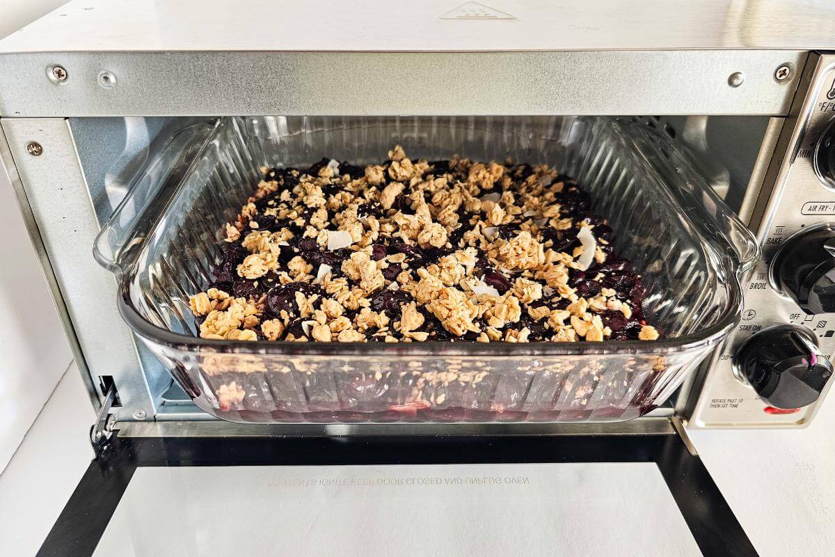 Gluten free cherry crisp being baked in an air fryer.