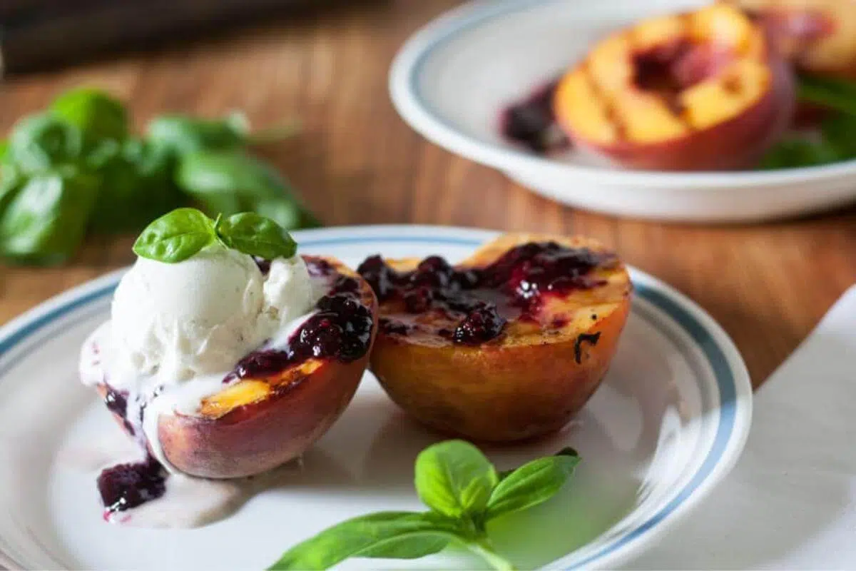 Grilled peaches on a plate.