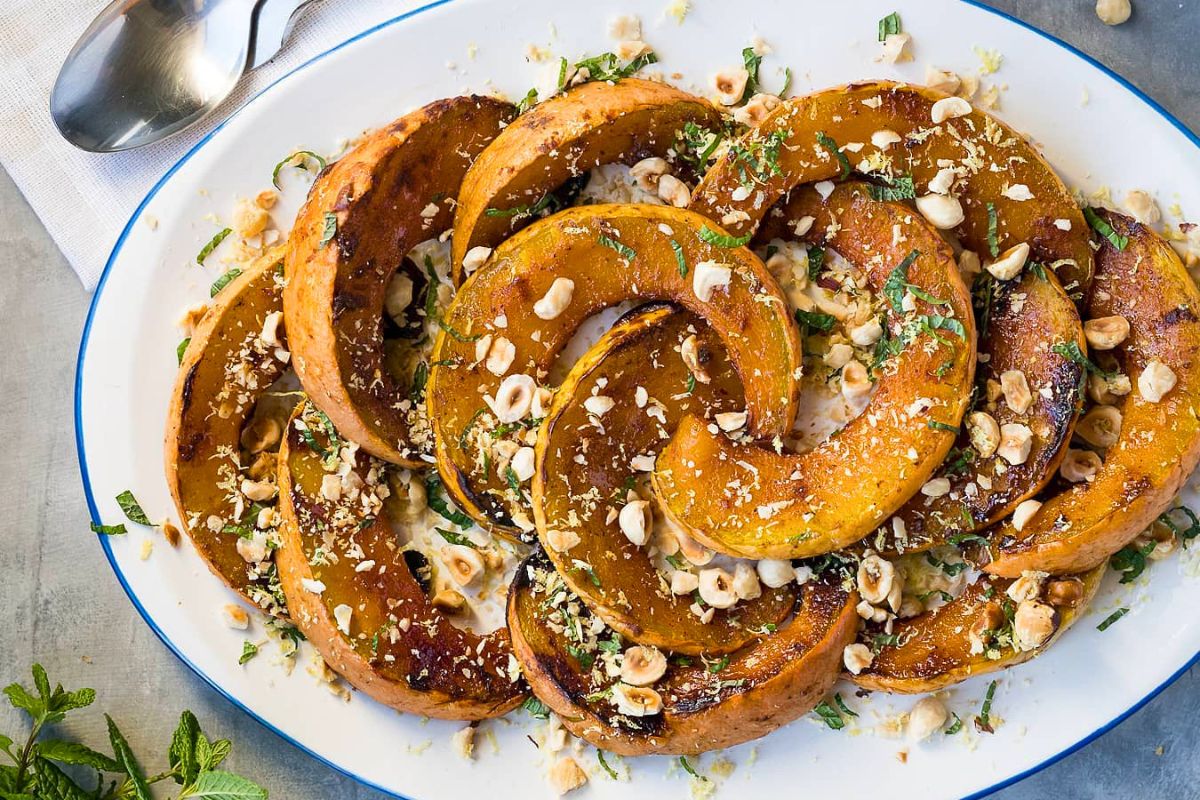 Maple Roasted Pumpkin with Hazelnuts and Mint served on a plate.