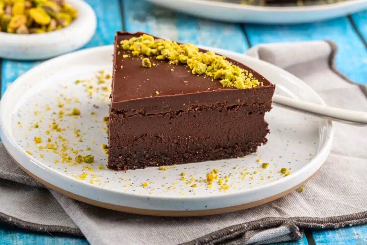 A slice of No-Bake Vegan Date and Chocolate Cake served on a plate.