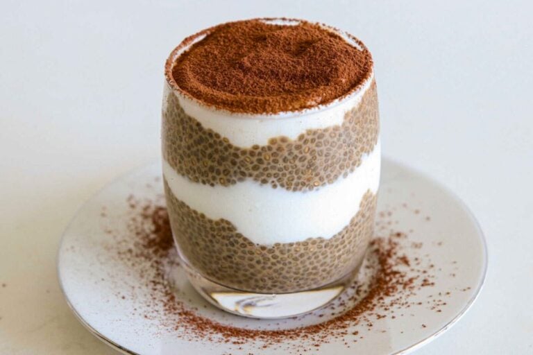 A glass of Tiramisu Chia Pudding topped with cinnamon powder.