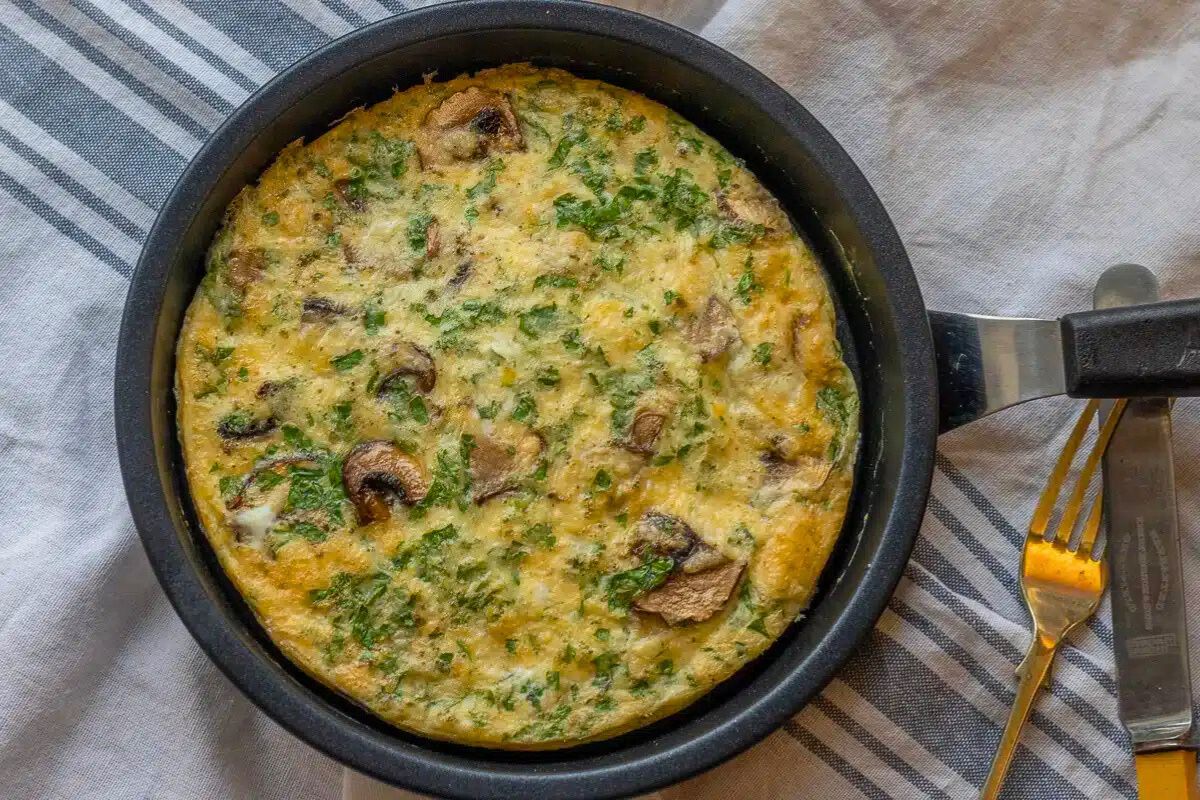 Air Fryer Mushroom and Cheese Omelette in a pan.
