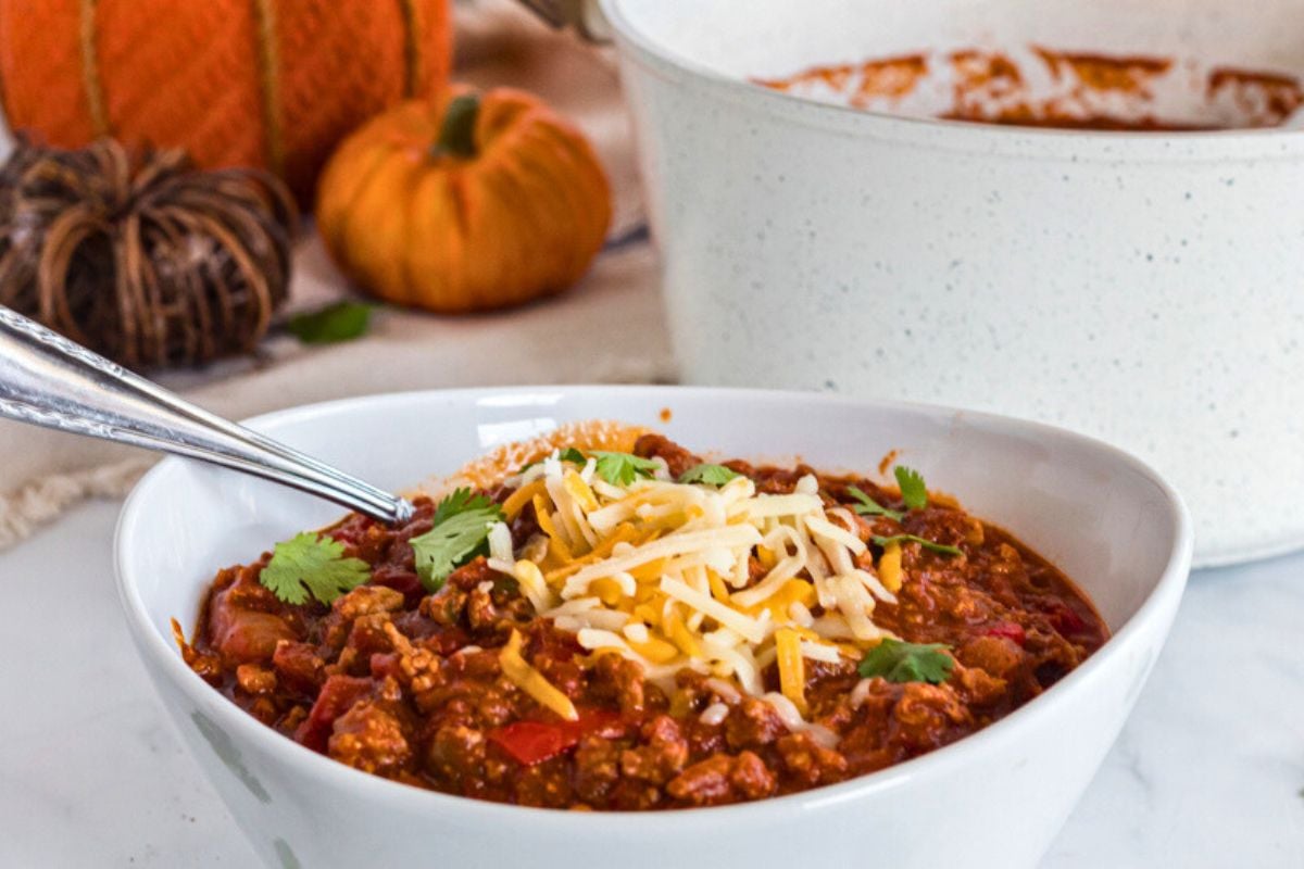 Pumpkin Chili topped with shredded cheese.