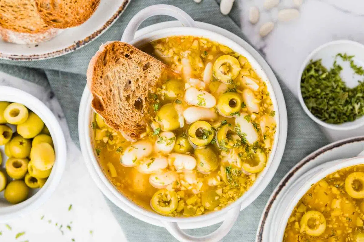 Green Olive Soup with Olive Oil served in a bowl.