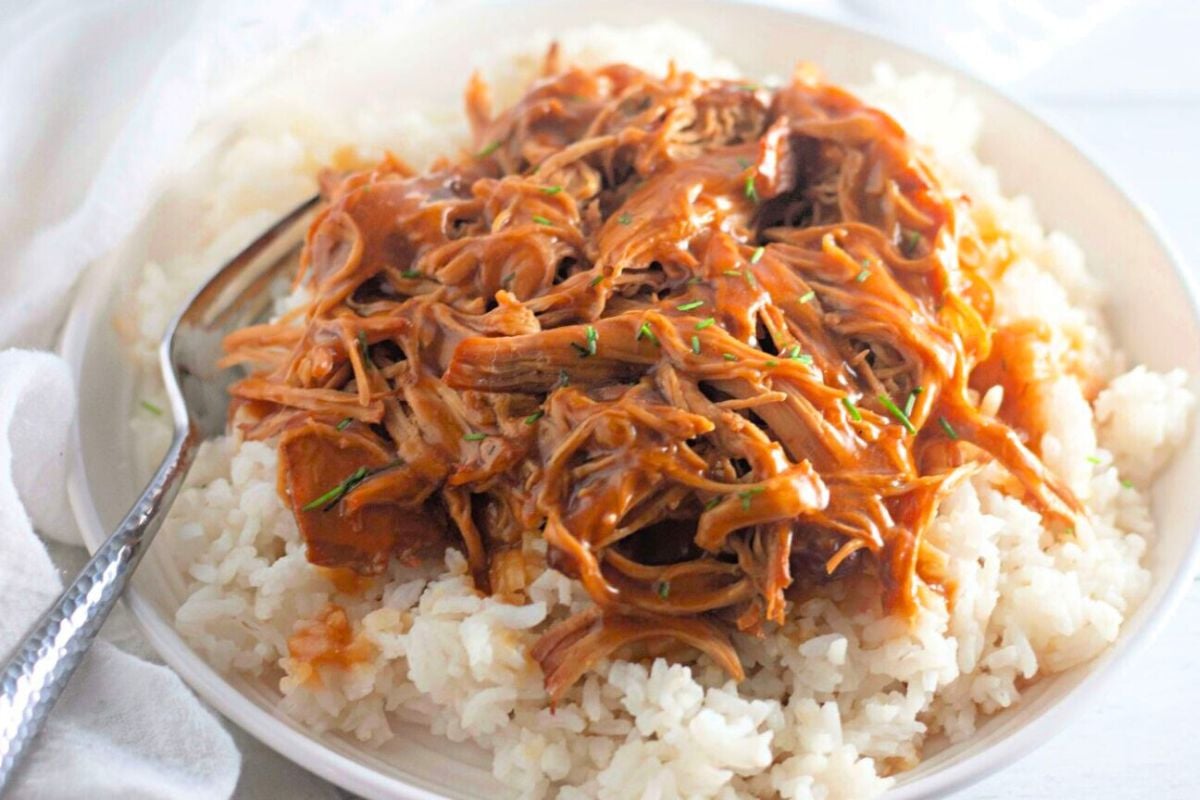 Crockpot Chicken topped on rice.