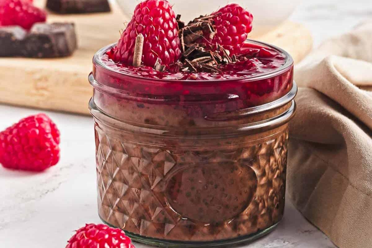 Chocolate chia seed pudding with berries on top.