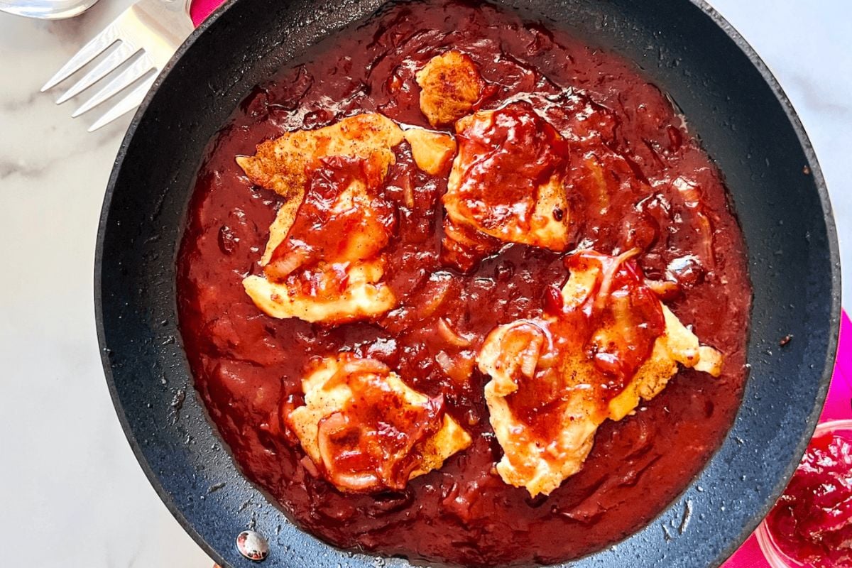 Cranberry Chicken Thighs in a pan.